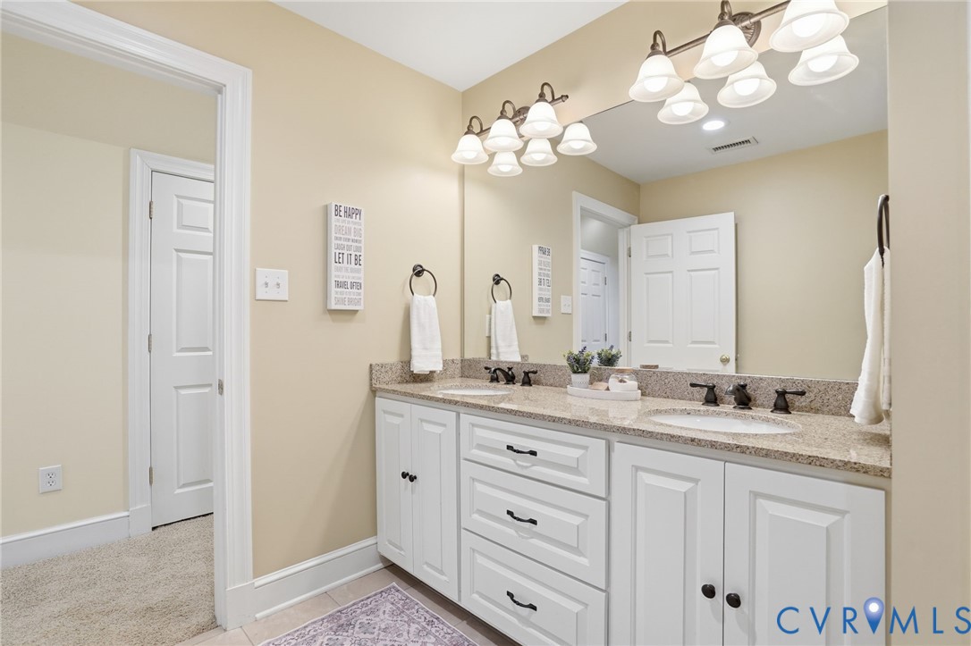 12123 Deer Ridge Court Ashland, VA 23005 - Photo 46 of 63 a bathroom with a granite countertop double vanity sink mirror and lamp