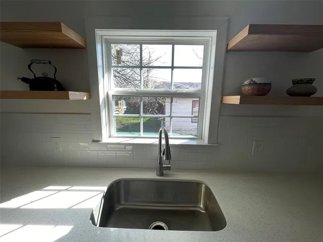 a sink sitting next to a window