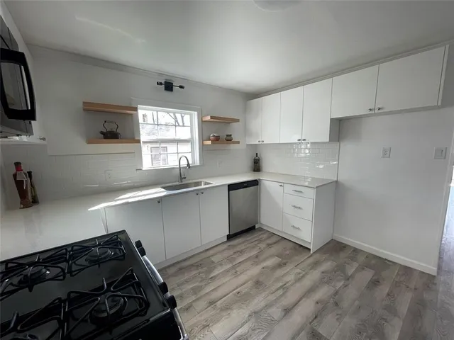 a kitchen with a sink stove and cabinets