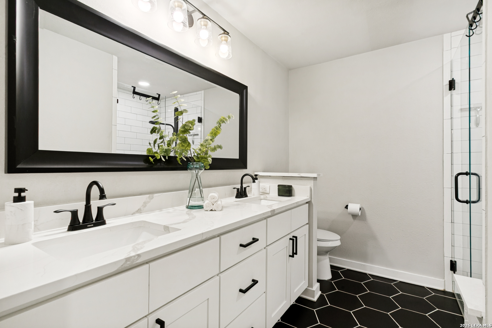 102 Silver Spring Universal City, TX 78148 - Photo 21 of 36 a bathroom with a double vanity sink mirror and toilet