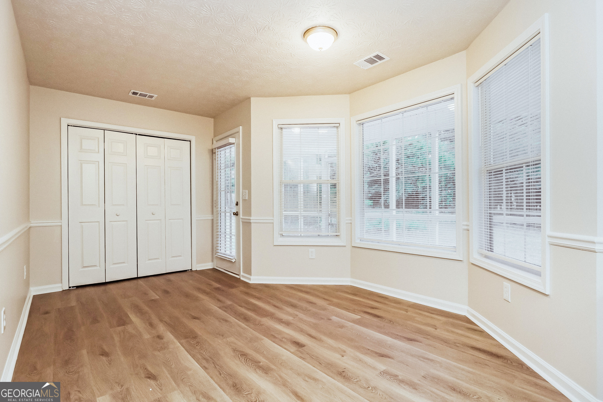 35 Spring Valley Keep Covington, GA 30016 - Photo 5 of 16 a view of empty room with wooden floor and fan