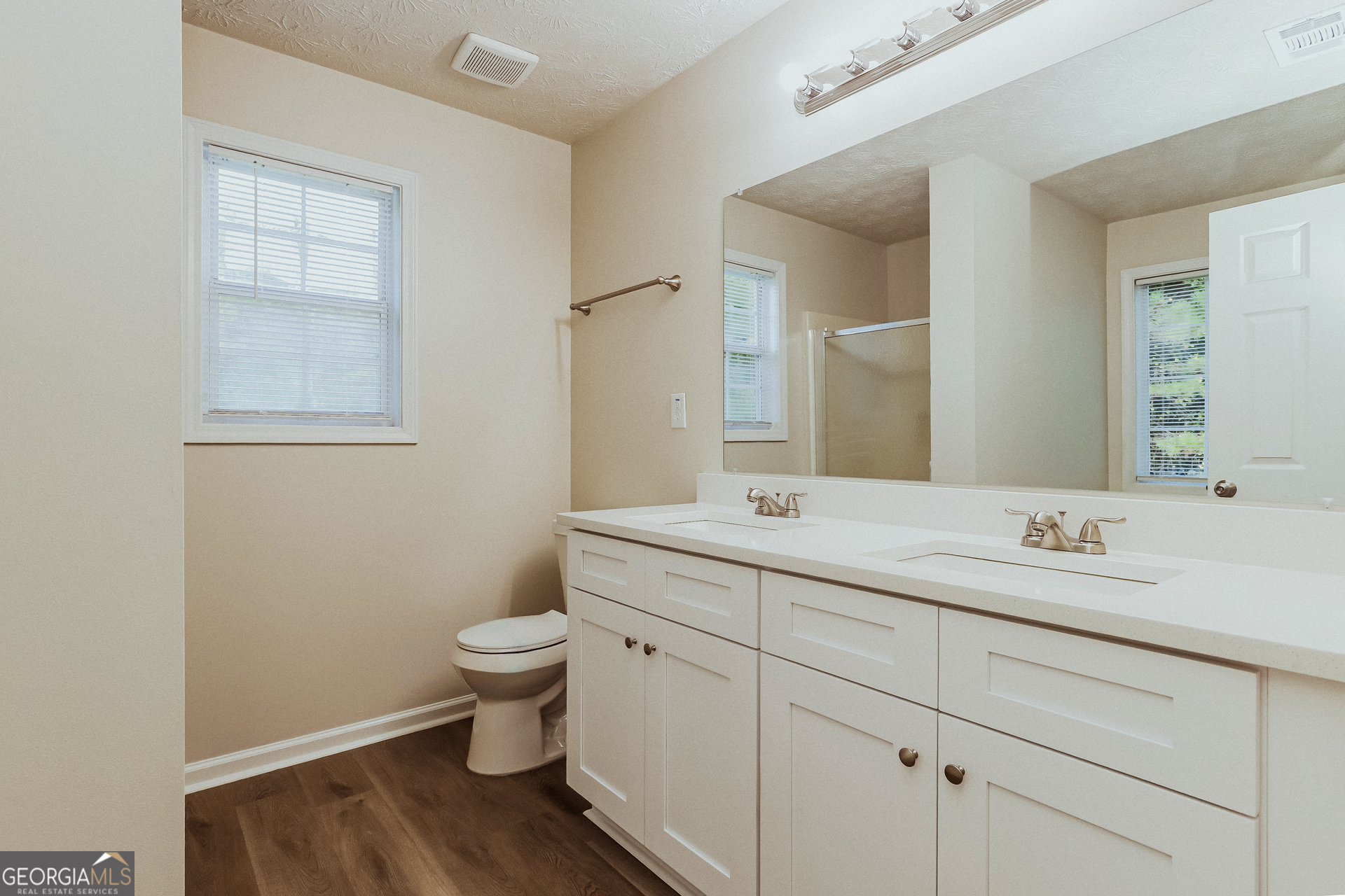 35 Spring Valley Keep Covington, GA 30016 - Photo 10 of 16 a bathroom with a double vanity sink toilet and a mirror