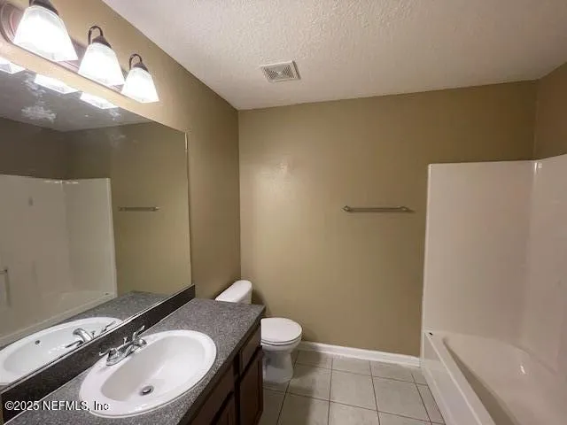 a bathroom with a granite countertop sink toilet a mirror and a shower