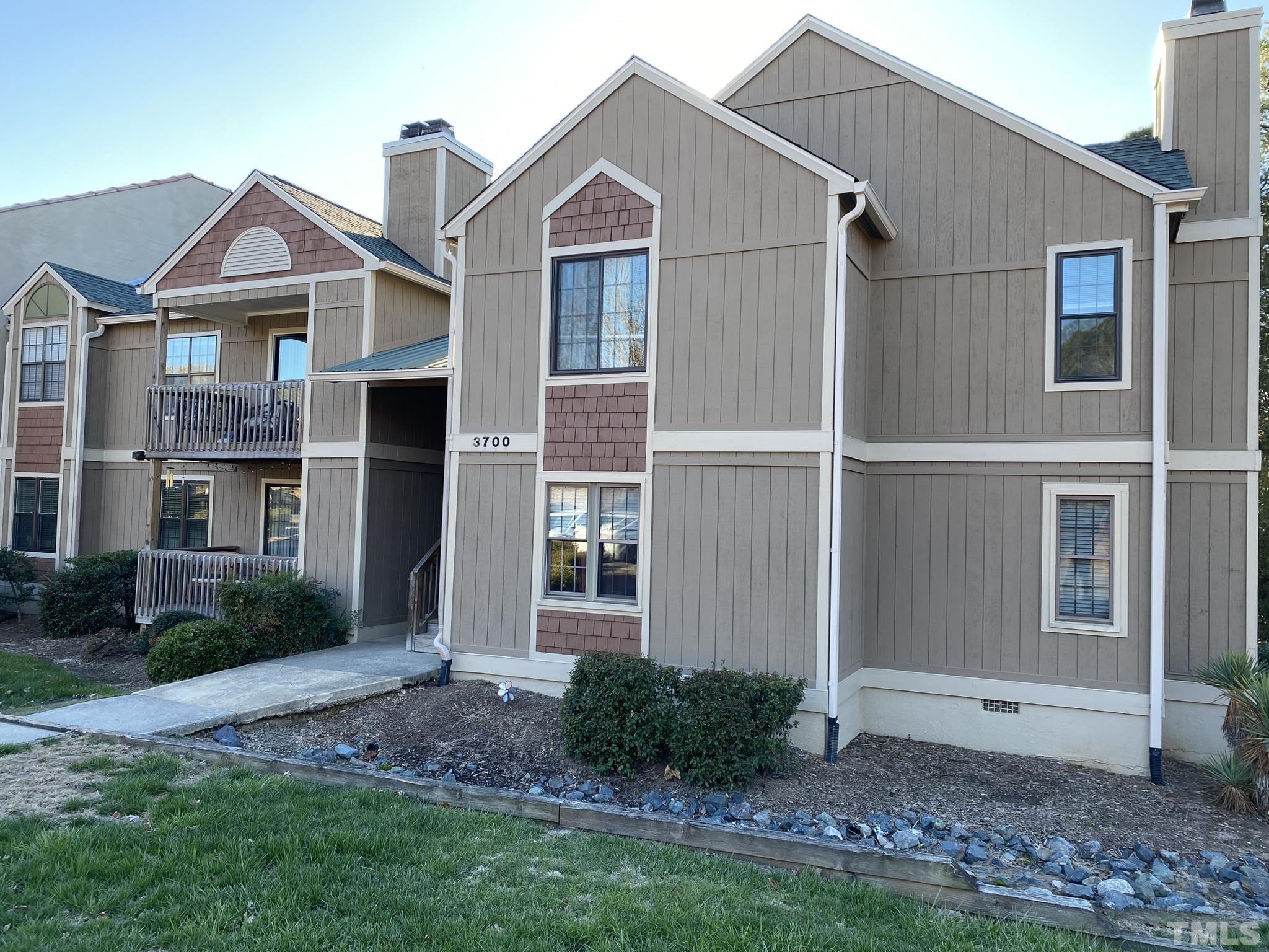 3700 Chimney Ridge Place, Unit 104 Durham, NC 27713 - Photo 1 of 17 a front view of a house with garden