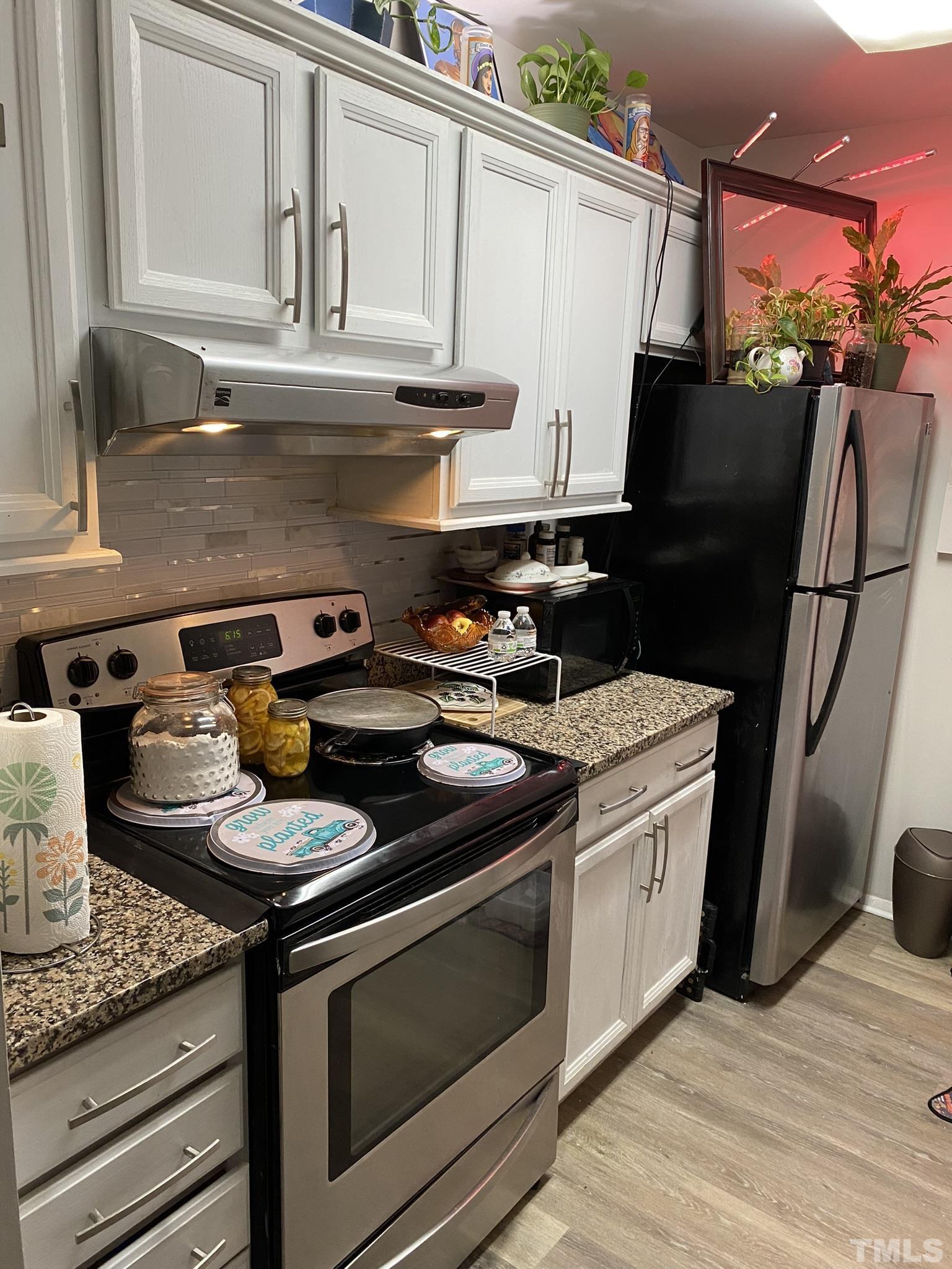 3700 Chimney Ridge Place, Unit 104 Durham, NC 27713 - Photo 5 of 17 a stove top oven sitting inside of a kitchen