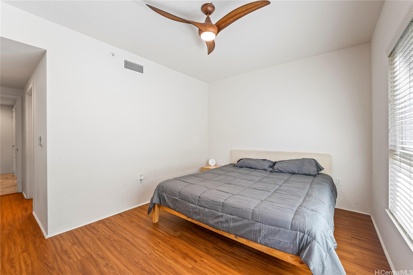 437 Kailua Road, Unit 6102 Kailua, HI 96734 - Photo 15 of 22 a bedroom with a bed and wooden floor