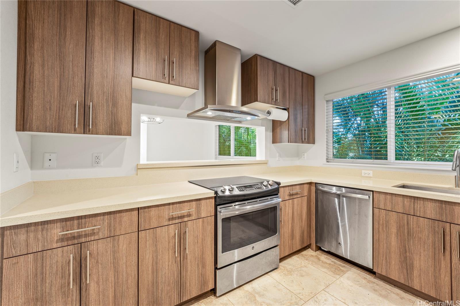 437 Kailua Road, Unit 6102 Kailua, HI 96734 - Photo 4 of 22 a kitchen with a stove sink and cabinets