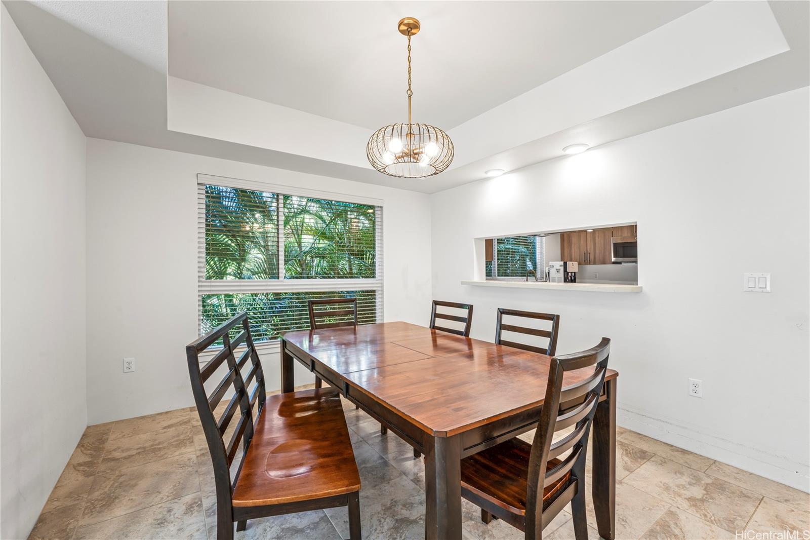 437 Kailua Road, Unit 6102 Kailua, HI 96734 - Photo 7 of 22 a view of a dining room with furniture window and wooden floor
