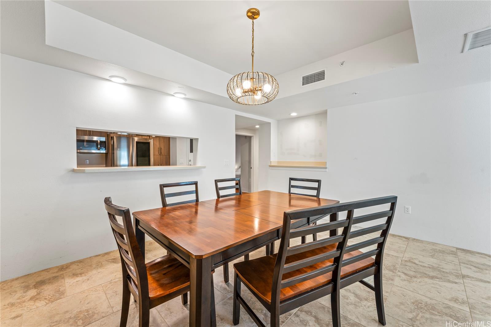 437 Kailua Road, Unit 6102 Kailua, HI 96734 - Photo 9 of 22 a dining room with furniture a chandelier and wooden floor