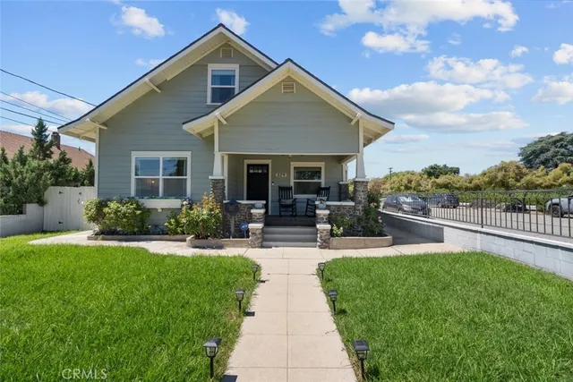 a view of a house with sitting area and garden