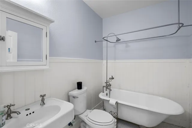 a white toilet sitting next to a bathroom sink