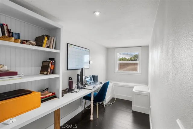 a view of a workspace with furniture and wooden floor