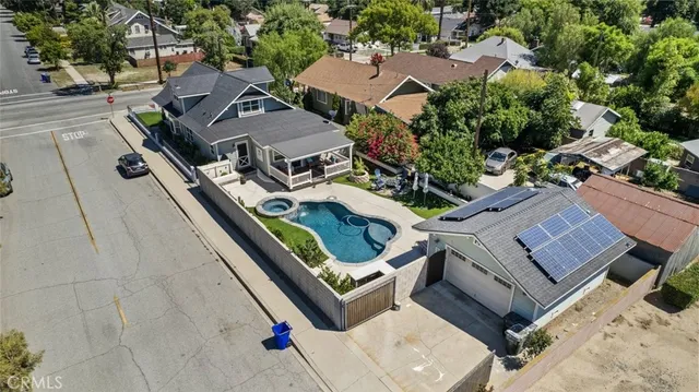 an aerial view of a residential houses with yard