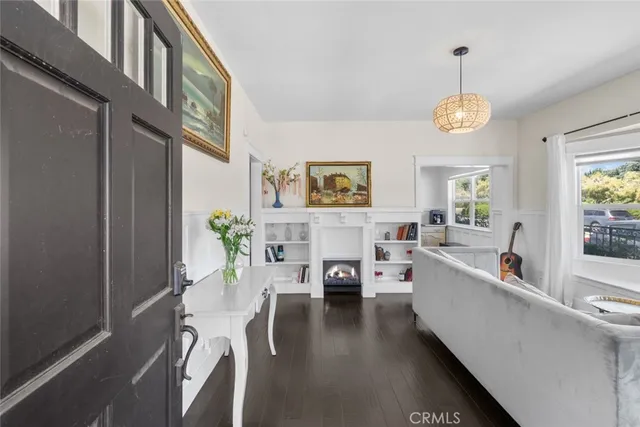 a living room with fireplace furniture and a chandelier