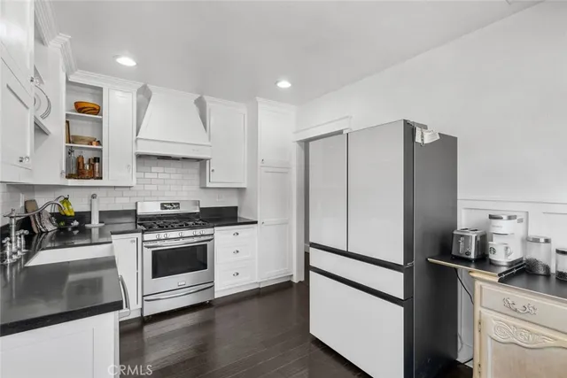 a kitchen with stainless steel appliances a stove a refrigerator and a sink