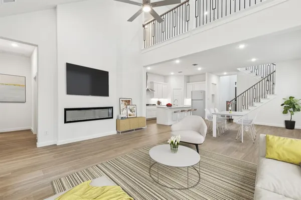a living room with furniture and kitchen view