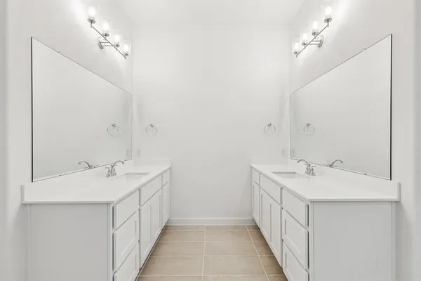 a bathroom with a double vanity sink and a mirror