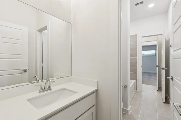 a bathroom with a sink vanity and a mirror