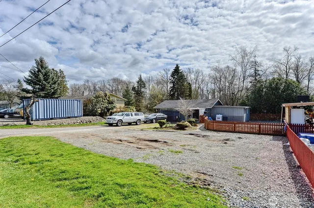 a backyard of a house with table and chairs