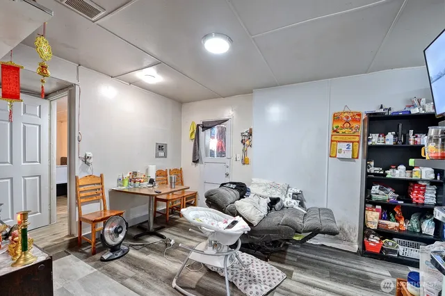 a living room with lots of furniture and wooden floor