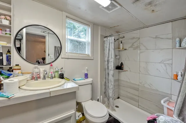 a bathroom with a sink toilet and shower