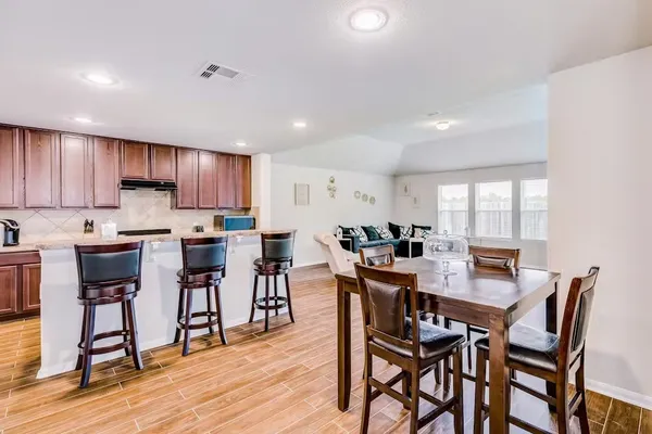 a view of a dining room with furniture and wooden floor