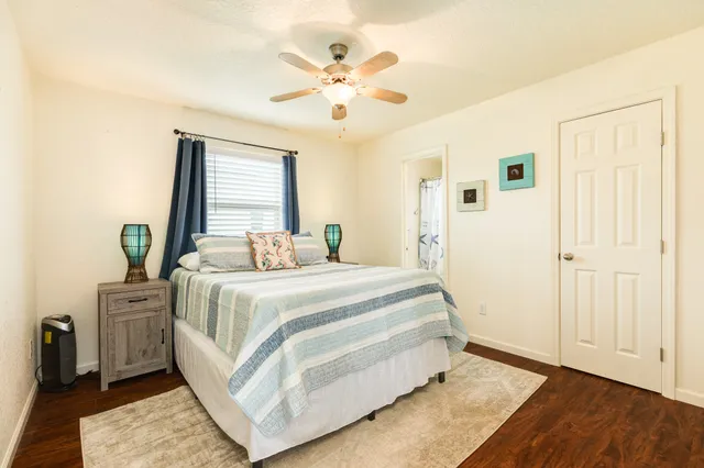 a bedroom with a bed and wooden floor