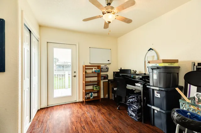 a view of a workspace with furniture and a window