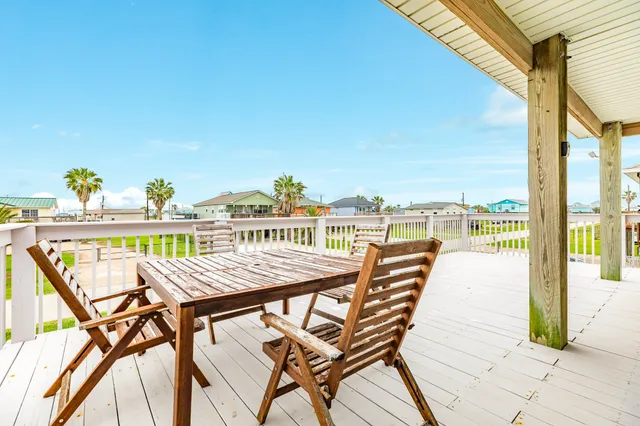 a view of a balcony with table and chairs
