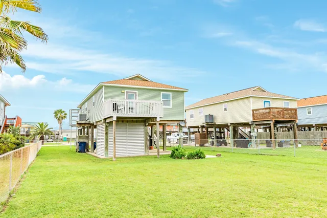 a front view of a house with swimming pool having outdoor seating