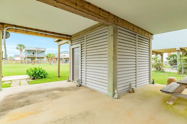 a view of a patio with a table and chairs next to a yard