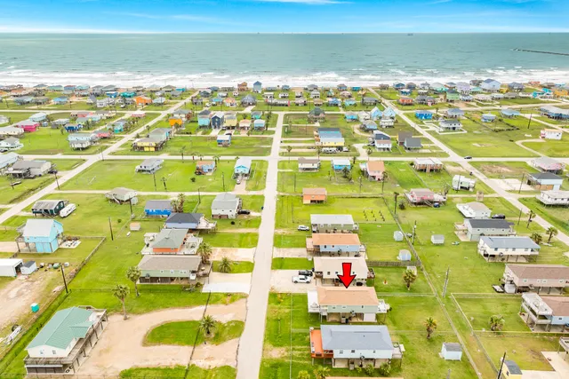 a view of a house with a chairs and table in a patio