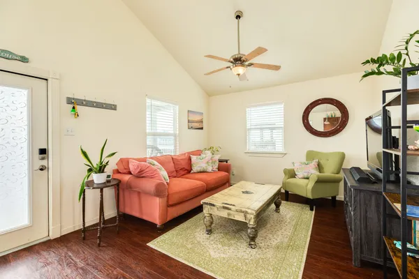 a living room with furniture and wooden floor