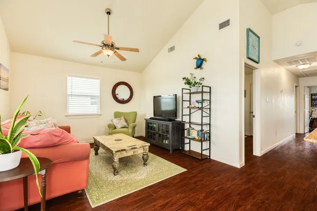 a living room with furniture and wooden floor