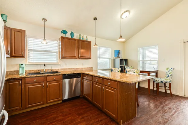 a kitchen with lots of counter space sink and wooden floor