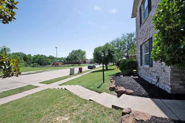 a view of a park with large trees