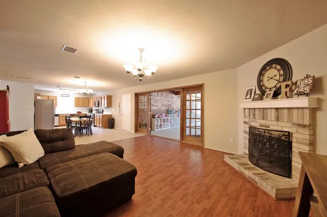 a view of a dining room with furniture and a chandelier