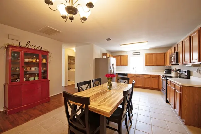 a kitchen with stainless steel appliances granite countertop a refrigerator sink and cabinets
