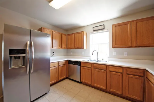 a kitchen with stainless steel appliances granite countertop a sink stove and microwave