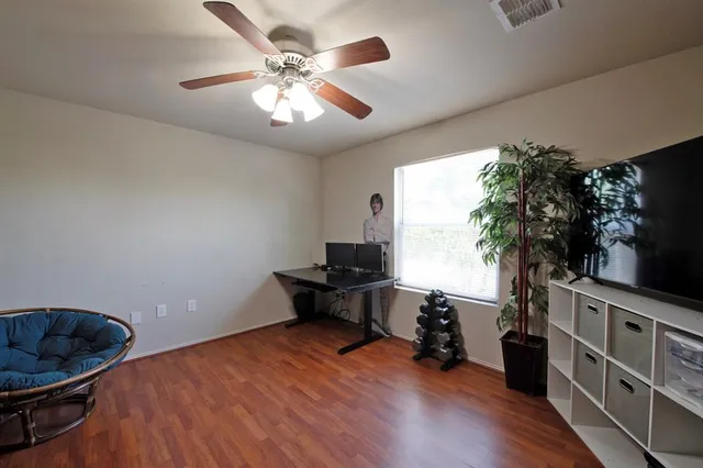 a living room with furniture and a book shelf