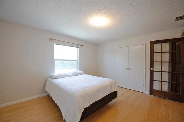 a bedroom with a large bed and a large window