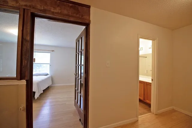 a bedroom with a bed and a large mirror on dresser