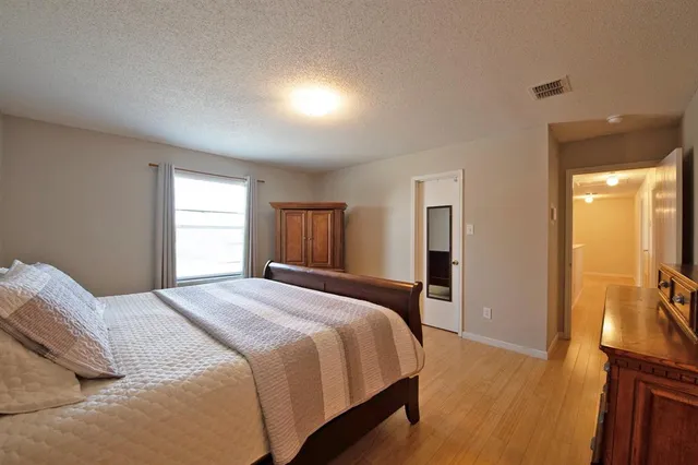 a bed room with a bed and a television