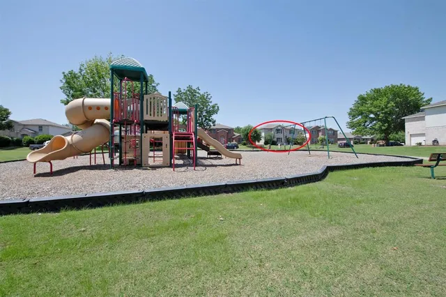 a view of a backyard with swimming pool