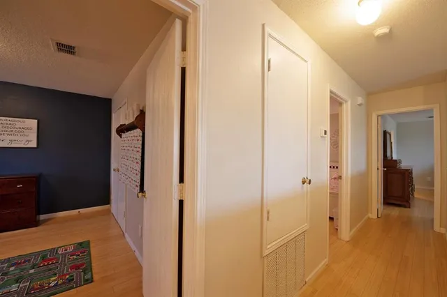 a bedroom with a bed and painting on the wall