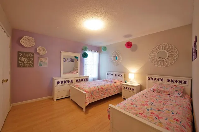 a bedroom with two beds and a window