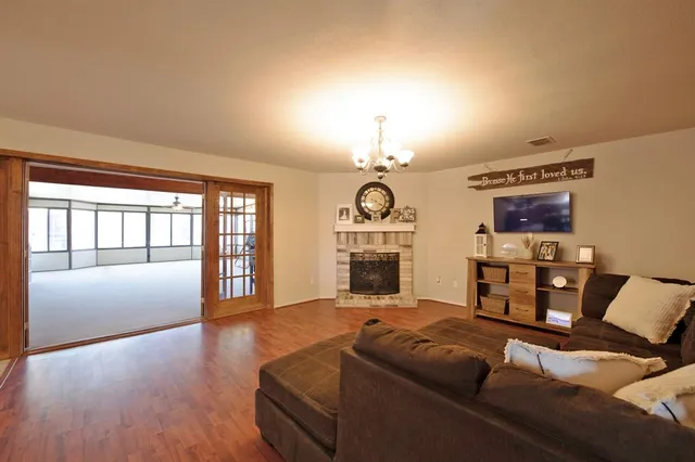 a living room with furniture fireplace and flat screen tv