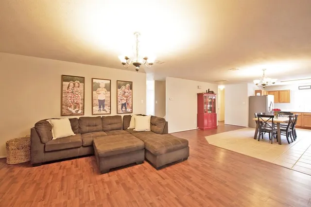 a living room with furniture and a chandelier