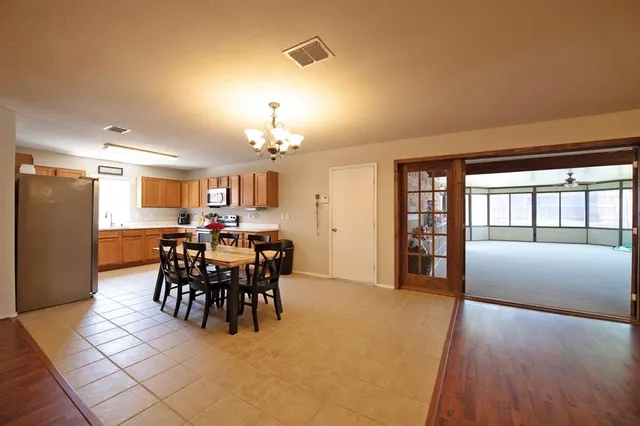 a view of a dining room with furniture and chandelier