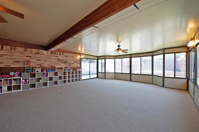 a view of an empty room with windows